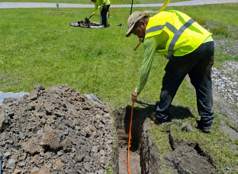 Technician locating the bore path before fiber pull